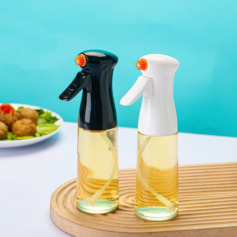 Two spray bottles with oil on a wooden board against a blue background